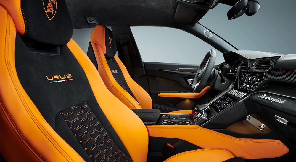 The black and oranger interior is shown in a 2022 Lamborghini Urus.