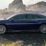 A blue 2022 Toyota Avalon Limited is shown from the side parked on a beach.
