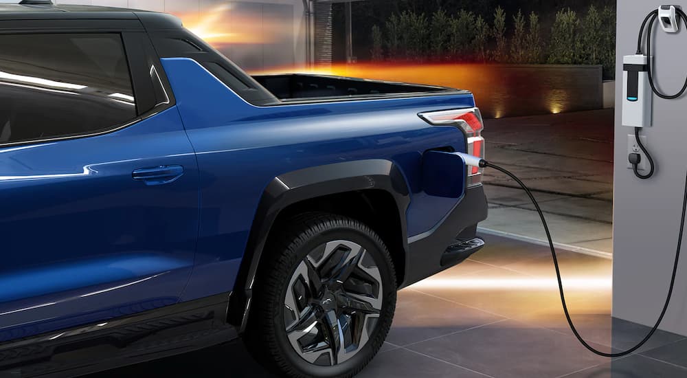 A close up of a 2024 Chevy Silverado EV is shown parked at an EV charging station.