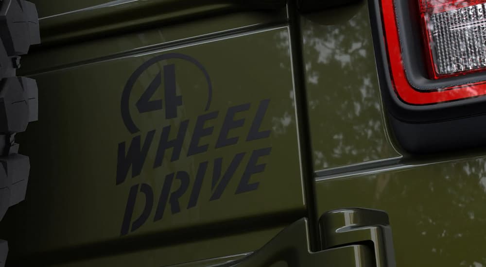 A close up of the 4-Wheel Drive sticker on a green 2021 Jeep Wrangler Willy is shown.