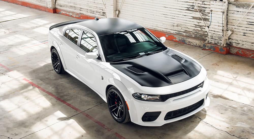 A white and black accented 2021 Charger SRT Hellcat Redeye is shown from a high angle parked in a garage.