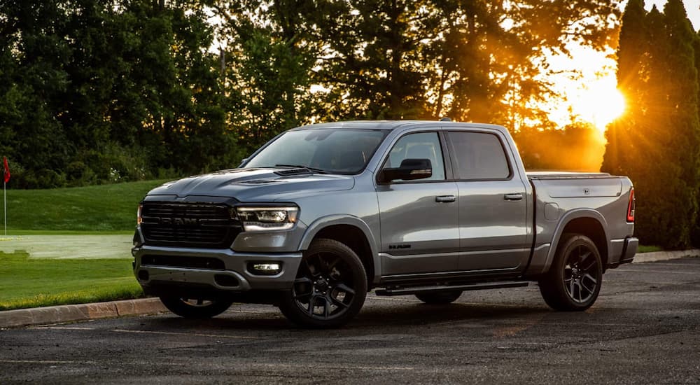 A silver 2022 Ram 1500 is shown parked from the side after leaving a Ram dealer near you.