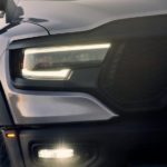A close up of the grille and headlights of a silver 2022 Ram 1500 TRX is shown.