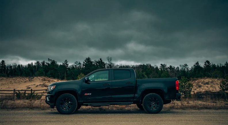 A black 2018 Chevy Colorado Z71 is shown from the side on an overcast day.