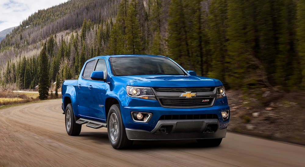 A blue 2020 Chevy Colorado ZR1 is shown from the front driving on a dirt road.