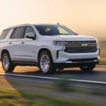 A white 2022 Chevy Tahoe is shown from the side driving on an open road after winning a 2022 Chevy Tahoe vs 2022 Ford Expedition comparison.