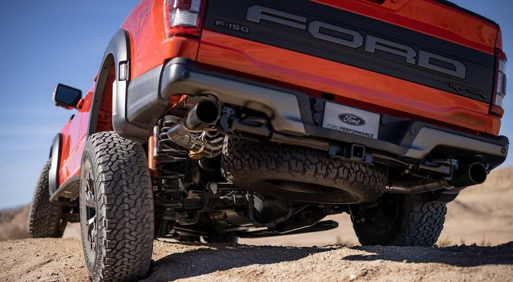The suspension is shown on an orange 2022 Ford F-150 Raptor.