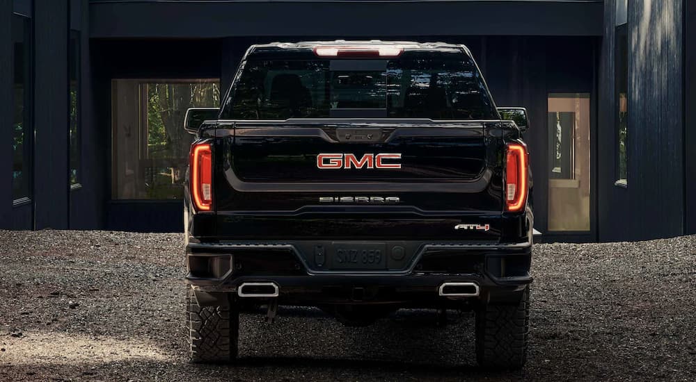A black 2022 GMC Sierra 1500 Limited AT4 is shown from the rear parked in a driveway.