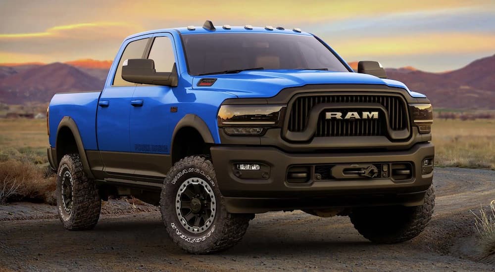 A Blue 2022 Ram 2500 Power Wagon is shown from the front at an angle in the desert.