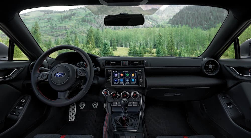 The black interior of a 2022 Subaru BRZ Limited shows the steering wheel and center console.