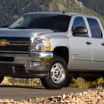 A silver 2012 Chevy Silverado 2500 is shown after leaving a used diesel truck dealer.