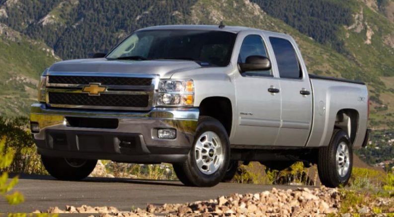 A silver 2012 Chevy Silverado 2500 is shown after leaving a used diesel truck dealer.