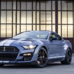 A grey 2022 Ford Mustang Shelby GT500 Heritage Edition is shown in from of a glass and metal building.
