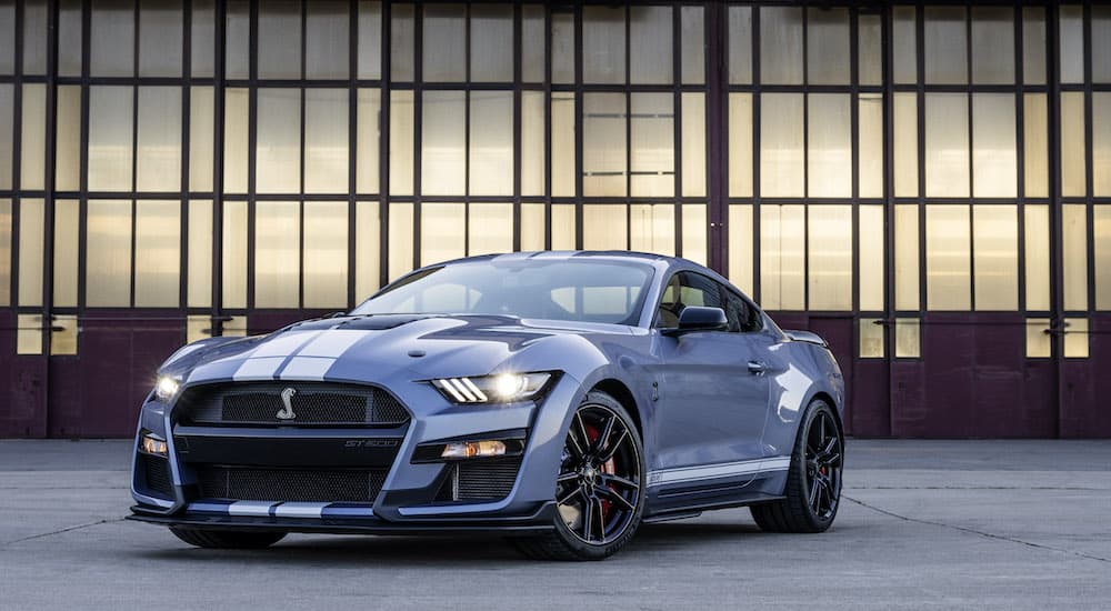 A grey 2022 Ford Mustang Shelby GT500 Heritage Edition is shown in from of a glass and metal building.