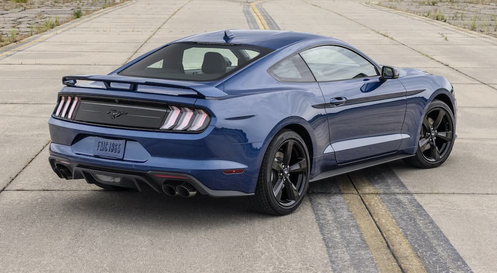 A blue 2022 Ford Mustang Stealth Edition is shown from the rear parked on concrete.