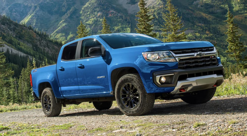 A blue 2022 Chevy Colorado is shown parked in a field.