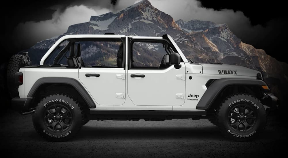 A white 2022 Jeep Wrangler Willys Sport is shown from the side.