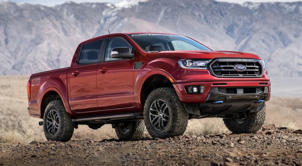 A red 2022 Ford Ranger is shown from the side parked in the mountains.