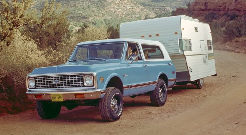 A blue 1969 Chevy K5 is shown from the front towing a trailer.