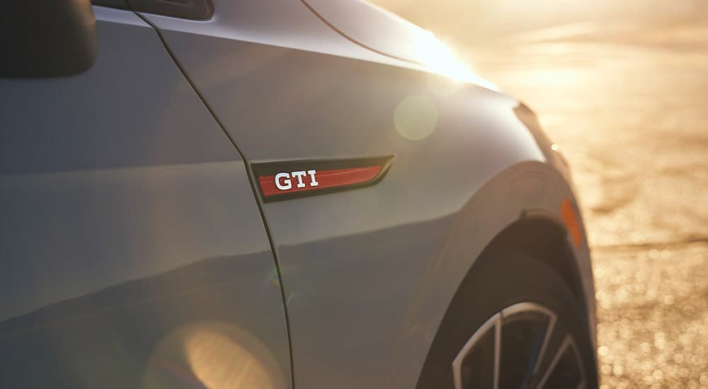 The GTI badge is shown in close up on a grey 2022 Volkswagen Golf GTI.
