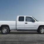 A first generation 2000 Chevy Silverado 1500 is shown parked from the side after looking at used trucks.