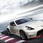 A white 2020 Nissan 370Z Nismo is shown from the front while rounding a racetrack corner after leaving a used Nissan dealership.