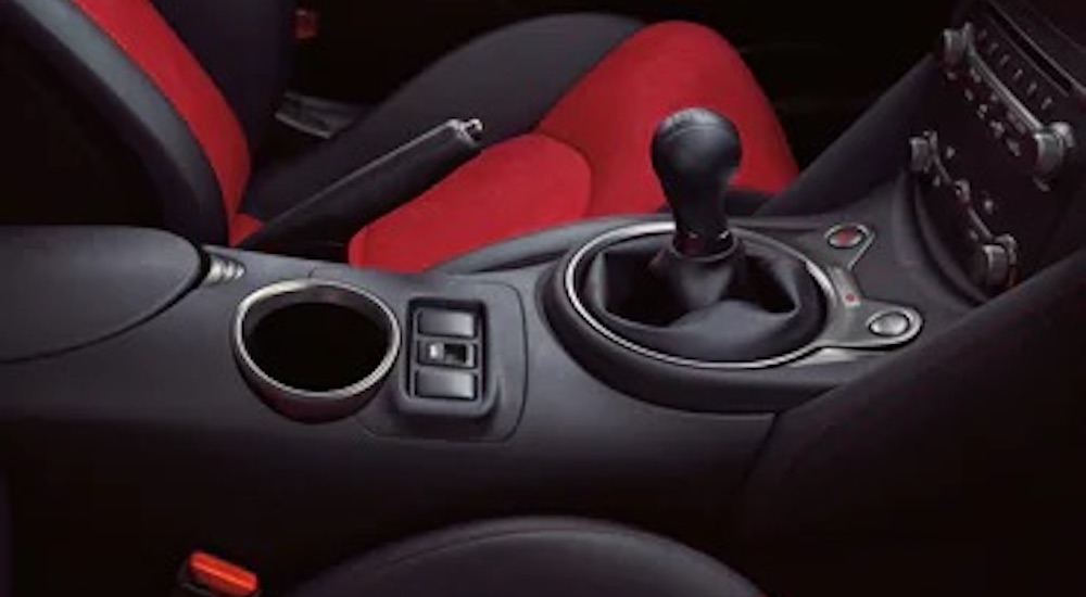 The interior of a 2020 Nissan 370Z Nismo is shown from the passenger door opening.