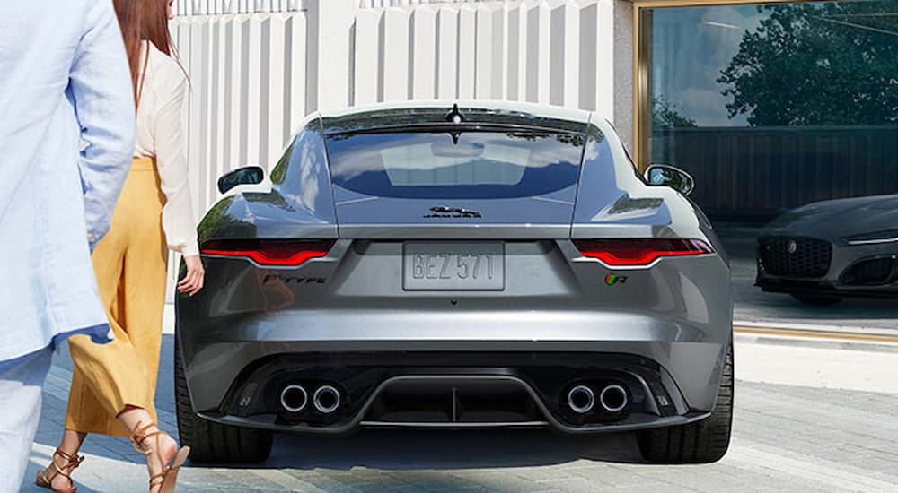 A grey 2022 Jaguar F-Type is shown from the rear while parked in a driveway.