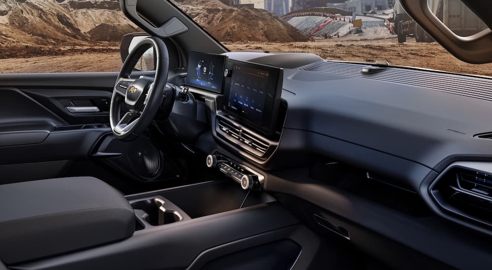 The black interior of a 2024 Silverado EV WT is shown from the passenger side opening.