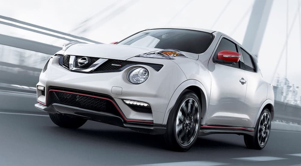 A silver 2017 Nissan Juke Nismo RS is shown driving on a bridge.
