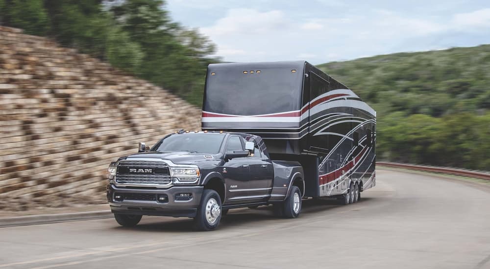A 2022 Ram 3500 is shown from the front while it hauls a large camper.
