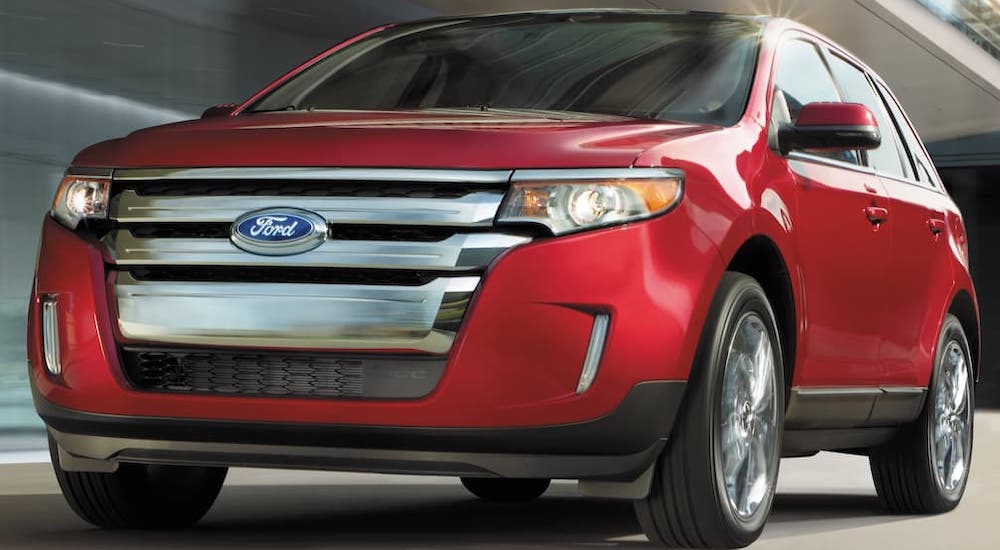 A red 2014 Ford Edge is shown from the front at an angle.