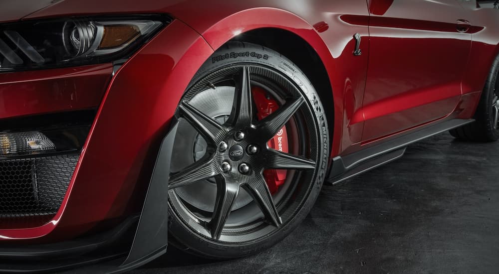 The wheel of a red 2023 Ford Mustang Shelby GT500 is shown from the side.