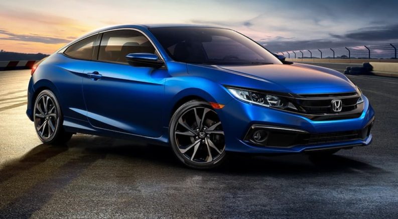 A blue 2020 Honda Civic Sport Coupe is shown from the front at an angle.