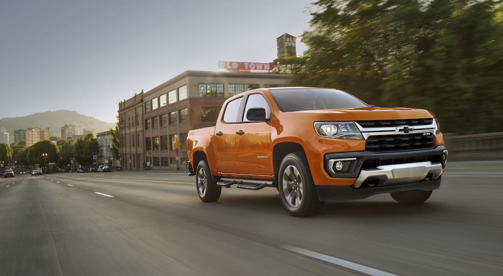 An orange 2021 Chevy Colorado is shown from the front at an angle.