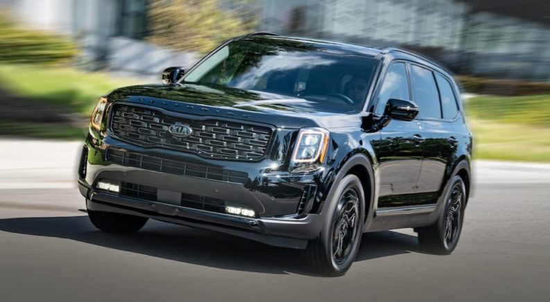 A black 2021 Kia Telluride is shown from the front at an angle after leaving a Kia Dealer.