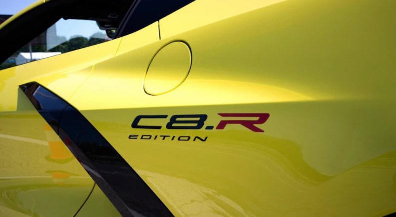 A close up of the C8.R Edition logo is shown on a yellow Chevy Corvette C8.R.