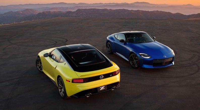 A yellow and a blue 2023 Nissan Z are shown parked in opposite directions.