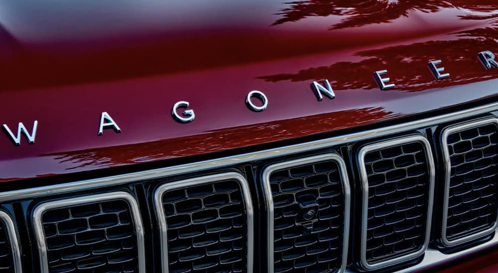 The Wagoneer logo and grille are shown in close up on a 2023 Wagoneer L.
