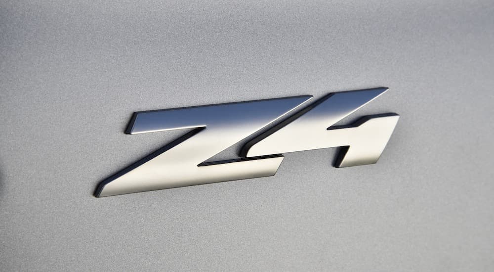 A close up shows the Z4 badge on a silver 2021 BMW Z4 M40i.