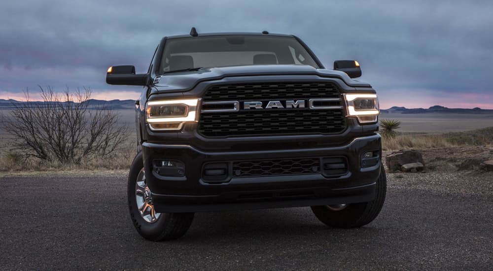 A black 2022 Ram 3500 is shown from the front after viewing used truck sales near you.