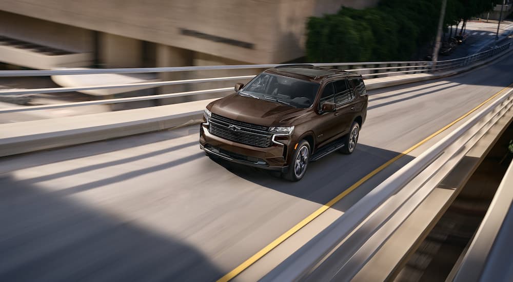 A brown 2023 Chevy Tahoe RST is shown from the front while on an onramp.