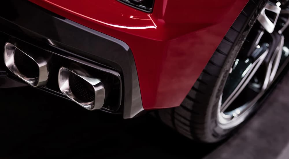 A close up of the exhaust on a red 2023 Corvette Stingray is shown.