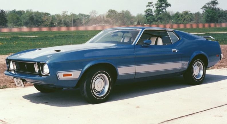 A blue 1973 Ford Mustang Mach-I is shown at an old Ford dealer.