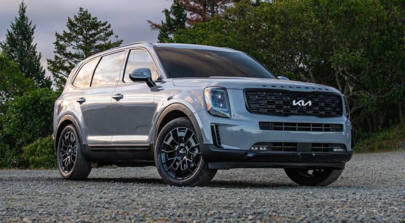 A silver 2022 Kia Telluride is shown parked on pavement after visiting a Kia dealership.