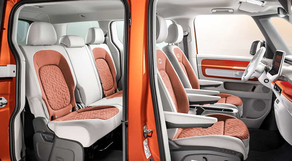 The interior of an orange 2023 VW ID.Buzz is shown from the passenger side door openings.