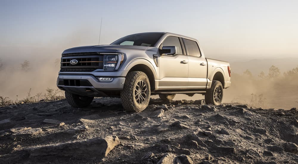 A silver 2022 Ford F-150 Tremor is shown from the front at an angle on top of a rocky area.