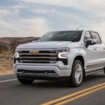 A white 2022 Chevy Silverado 1500 High Country is shown from the front at an angle during a 2022 Chevy Silverado 1500 vs 2022 Nissan Titan comparison.