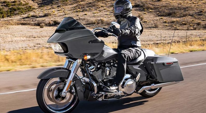 A person is shown riding a 2022 Harley-Davidson Road Glide Special on an open road.