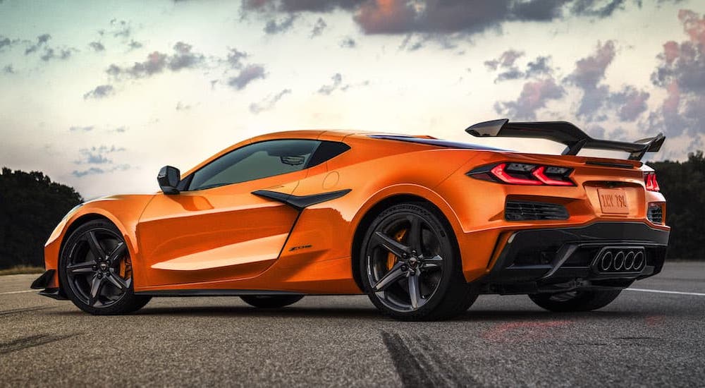 An orange 2023 Chevy Corvette Z06 is shown from the rear at an angle.